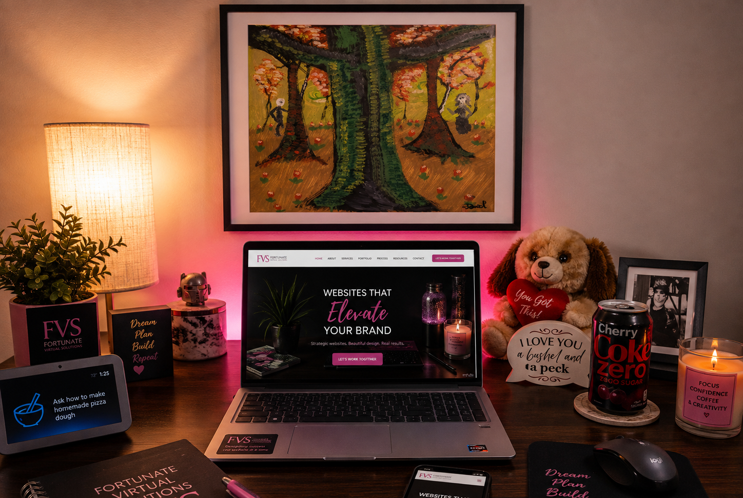 Randi's cozy home office with HP laptop showing the Fortunate Virtual Solutions website, Cherry Coke Zero, notebook, and warm lamp light