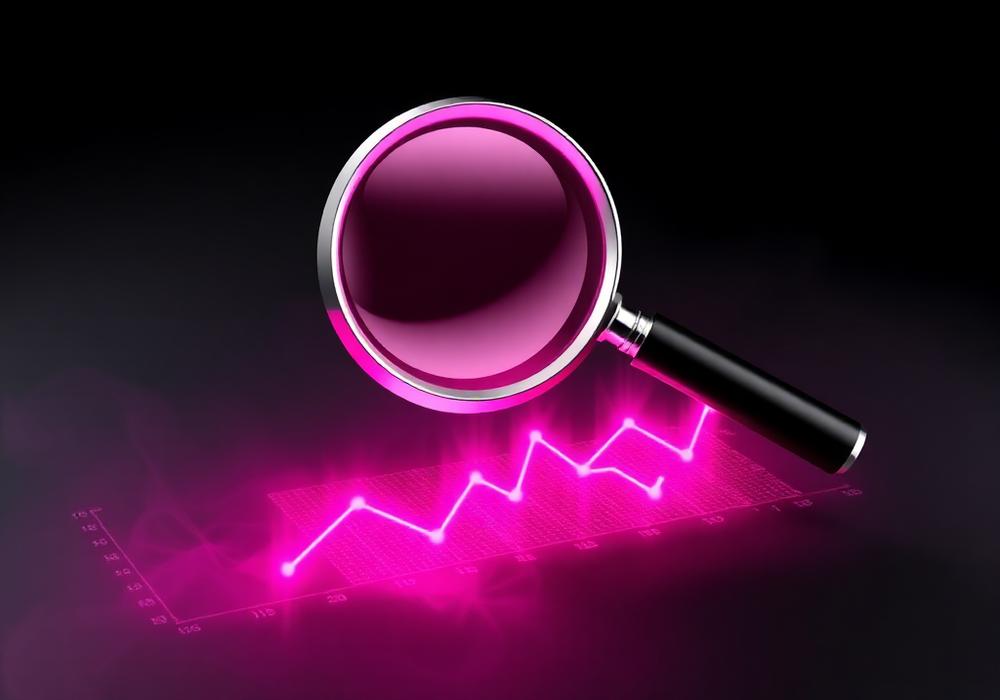 Magnifier over a glowing pink growth graph on a black background